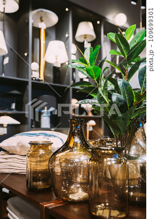 View of assortment of decor for interior shop in store of shopping center. Home accessories and household products for living room in store of shopping centre. View of decorative glass vessels on 109699301