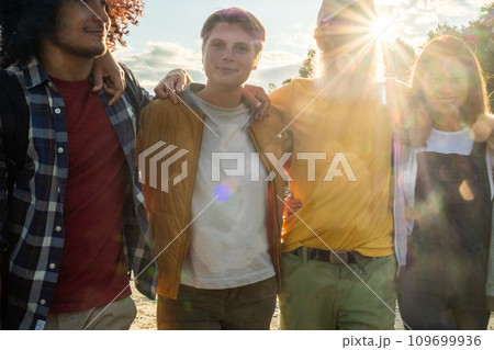 Golden Hour Camaraderie: A Close-knit Group in the Sunset Light 109699936