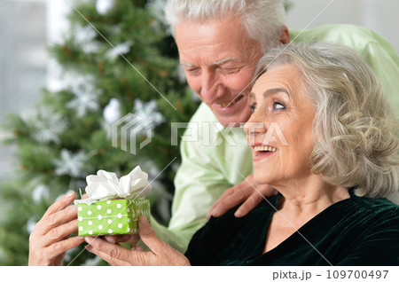 Happy elderly couple celebrating new year at home 109700497
