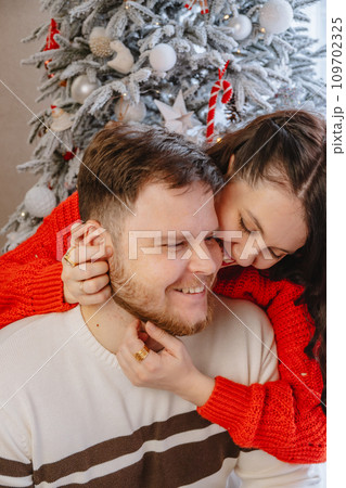portrait of beautiful couple christmas tree on background 109702325