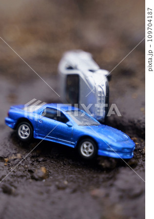 One car overturned on another as a result of a landslide. One of them is out of focus. One car overturned on another as a result of a landslide. One of them is out of focus. 109704187