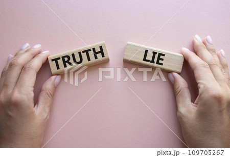 Truth or Lie symbol. Concept word Truth or Lie on wooden blocks. Businessman hand. Beautiful pink background. Business and Truth or Lie concept. Copy space 109705267