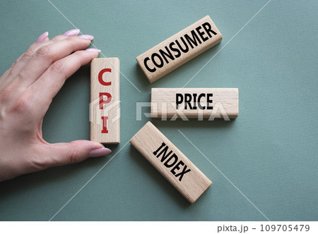 CPI - Consumer Price Index symbol. Concept word CPI on wooden blocks. Businessman hand. Beautiful grey green background. Business and CPI concept. Copy space. CPI - Consumer Price Index symbol. Concept word CPI on wooden blocks. Businessman hand. Beautiful grey green background. Business and CPI concept. Copy space. 109705479