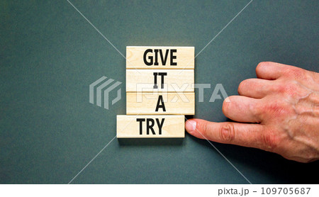 Give it a try symbol. Concept word Give it a try on beautiful wooden block. Beautiful grey table grey background. Businessman hand. Business give it a try concept. Copy space. Give it a try symbol. Concept word Give it a try on beautiful wooden block. Beautiful grey table grey background. Businessman hand. Business give it a try concept. Copy space. 109705687
