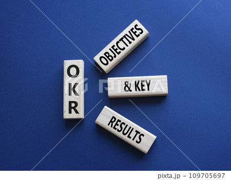 OKR objectives and key results symbol. Wooden blocks with words OKR objectives and key results. Beautiful deep blue background. Business and OKR concept. Copy space. 109705697
