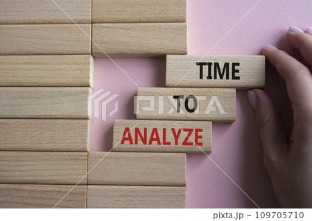 Time to Analyze symbol. Concept word Time to Analyze on wooden blocks. Businessman hand. Beautiful pink background. Business and Time to Analyze concept. Copy space 109705710