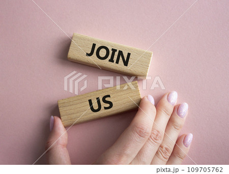 Join us symbol. Concept word Join us on wooden blocks. Beautiful pink background. Businessman hand. Business and Join us concept. Copy space Join us symbol. Concept word Join us on wooden blocks. Beautiful pink background. Businessman hand. Business and Join us concept. Copy space 109705762