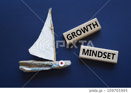 Growth Mindset symbol. Concept word Growth Mindset on wooden blocks. Beautiful deep blue background with boat. Business and Growth Mindset concept. Copy space 109705995
