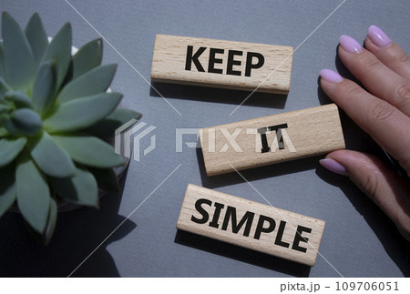 Keep it Simple symbol. Concept words Keep it Simple on wooden blocks. Businessman hand. Beautiful grey background with succulent plant. Business and Keep it Simple concept. Copy space. Keep it Simple symbol. Concept words Keep it Simple on wooden blocks. Businessman hand. Beautiful grey background with succulent plant. Business and Keep it Simple concept. Copy space. 109706051