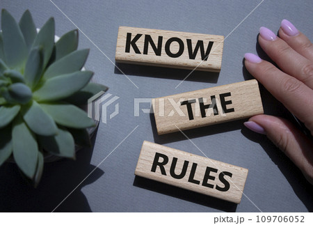 Know the rules symbol. Wooden blocks with words Know the rules. Businessman hand. Beautiful grey background with succulent plant. Business and Know the rules concept. Copy space. Know the rules symbol. Wooden blocks with words Know the rules. Businessman hand. Beautiful grey background with succulent plant. Business and Know the rules concept. Copy space. 109706052