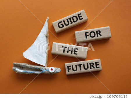 Guide for the future symbol. Wooden blocks with words Guide for the future. Beautiful orange background with boat. Business and Guide for the future concept. Copy space. Guide for the future symbol. Wooden blocks with words Guide for the future. Beautiful orange background with boat. Business and Guide for the future concept. Copy space. 109706113
