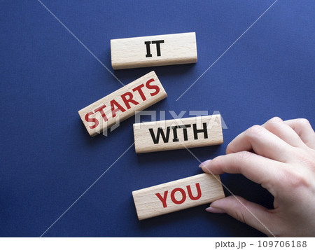 It starts with you symbol. Wooden blocks with words It starts with you. Beautiful deep blue background. Businessman hand. Business and It starts with you concept. Copy space. It starts with you symbol. Wooden blocks with words It starts with you. Beautiful deep blue background. Businessman hand. Business and It starts with you concept. Copy space. 109706188