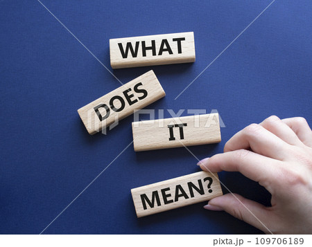 What does it mean symbol. Wooden blocks with words What does it mean. Beautiful deep blue background. Businessman hand. Business and What does it mean concept. Copy space. What does it mean symbol. Wooden blocks with words What does it mean. Beautiful deep blue background. Businessman hand. Business and What does it mean concept. Copy space. 109706189