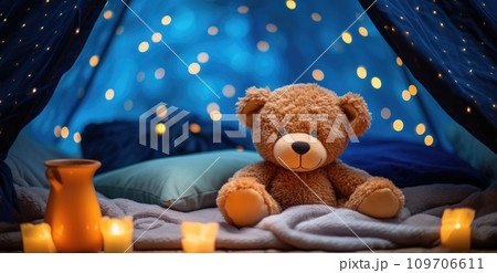 a bear is sitting on a blue blanket a bear is sitting on a blue blanket 109706611