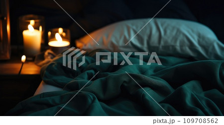 a bed is covered with blankets and candles 109708562