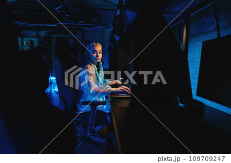 Young female cyber gamer, cosplayer plays computer games. 109709247