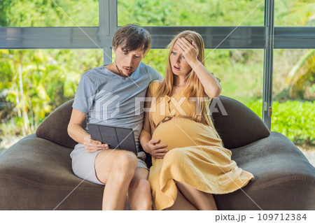 Cost of Pregnancy And Family Budgeting Concept. Young couple expecting baby, planning budget and counting spends at home Cost of Pregnancy And Family Budgeting Concept. Young couple expecting baby, planning budget and counting spends at home 109712384