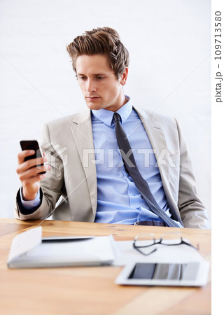Businessman, phone and networking or email in office, connection and contact for company. Male person, professional and communication or mobile application, technology and smartphone for discussion 109713580