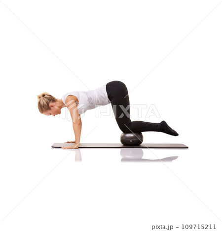 Fitness, pilates and woman on floor with ball for exercise, body building care and health in studio. Gym, training and girl on mat with cardio, energy and muscle workout isolated on white background Fitness, pilates and woman on floor with ball for exercise, body building care and health in studio. Gym, training and girl on mat with cardio, energy and muscle workout isolated on white background 109715211