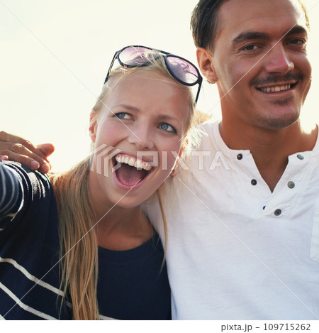 Portrait, hug and outdoor with couple, smile and happiness with love, vacation and holiday. People, romance and embrace with man, woman and event with joy, weekend break and cheerful with bonding 109715262