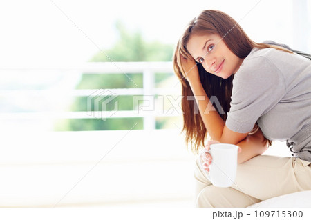 Happy, coffee and portrait of woman in home for relaxing, calm and peace on weekend. House, morning and face of person smile with mug for warm beverage, tea and drinking caffeine for happiness 109715300