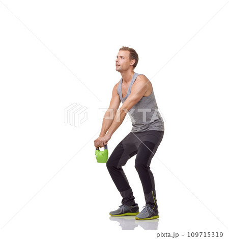 Training, exercise and studio man with kettlebell for muscle growth, strength development or weightlifting routine. Gym equipment, weight lifting hard work and strong body builder on white background Training, exercise and studio man with kettlebell for muscle growth, strength development or weightlifting routine. Gym equipment, weight lifting hard work and strong body builder on white background 109715319