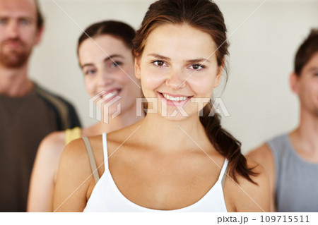 Portrait, smile or yoga and woman with a group of people in a studio for health, wellness or mindfulness. Fitness, exercise or pilates with happy young friends in gym class for holistic training 109715511