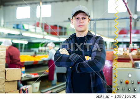 Young foreman of fruit factory standing on citrus sorting line Young foreman of fruit factory standing on citrus sorting line 109715800