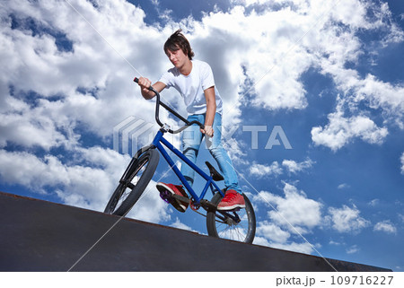 Ride, ramp and man with bike at park, event or competition for sport with risk, energy and freedom. Mockup, space or person in performance of stunt trick on bicycle for fun in summer with adventure 109716227