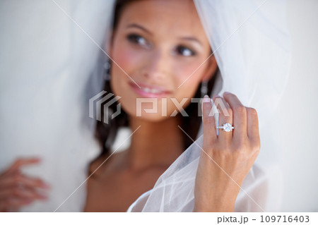 Diamond, wedding ring and hand of bride with jewellery and pride for commitment, celebration or marriage. Bridal, aesthetic and woman closeup with engagement jewelry, fashion and veil fabric Diamond, wedding ring and hand of bride with jewellery and pride for commitment, celebration or marriage. Bridal, aesthetic and woman closeup with engagement jewelry, fashion and veil fabric 109716403