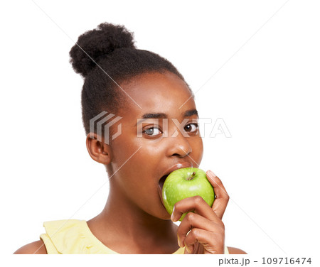 Eating, health and portrait of girl and apple in studio for nutrition, wellness or diet. Food, self care and vitamin c with face of African student and fruit on white background for fiber and balance Eating, health and portrait of girl and apple in studio for nutrition, wellness or diet. Food, self care and vitamin c with face of African student and fruit on white background for fiber and balance 109716474