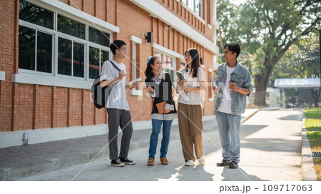 Group of diverse cheerful Asian students friends are enjoying talking while walking in their campus. Group of diverse cheerful Asian students friends are enjoying talking while walking in their campus. 109717063