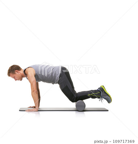 Pilates, foam roller and man in a studio for exercise, stretching or gym routine with yoga mat. Stability, balance and young male athlete from Australia with body workout by white background. 109717369