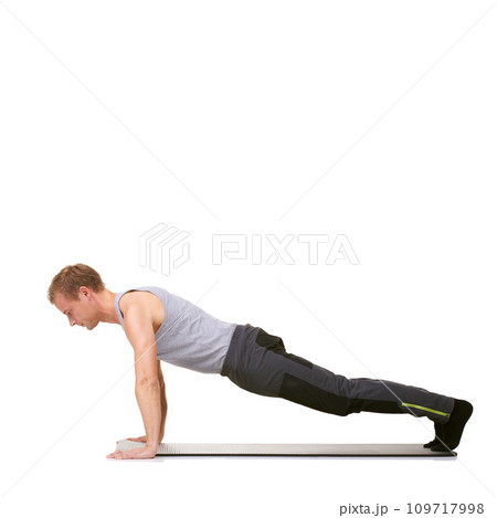 Man, workout and mat in studio for push ups, fitness or exercise for healthy body, wellness or core muscle. Person, balance and training on floor or abdomen health on mockup space or white background Man, workout and mat in studio for push ups, fitness or exercise for healthy body, wellness or core muscle. Person, balance and training on floor or abdomen health on mockup space or white background 109717998