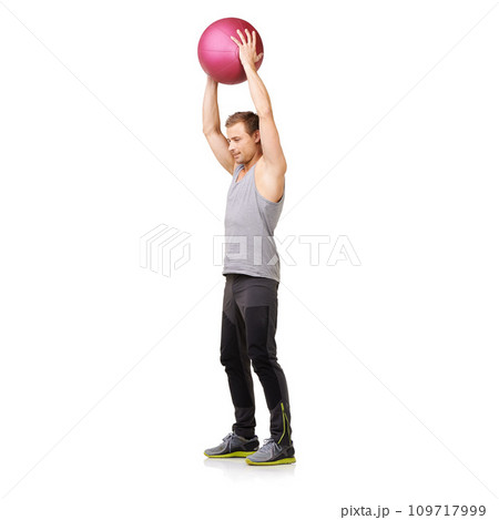 Man, medicine ball and gym workout in studio for training exercise, balance goal or white background. Male person, sports equipment and muscle fitness or mockup space for healthy, cardio or strong 109717999