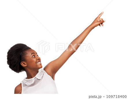 Smile, pointing and portrait of black girl in studio with mockup space for marketing or advertising. Happy, sale and gen z African child with positive face expression isolated by white background. 109718400