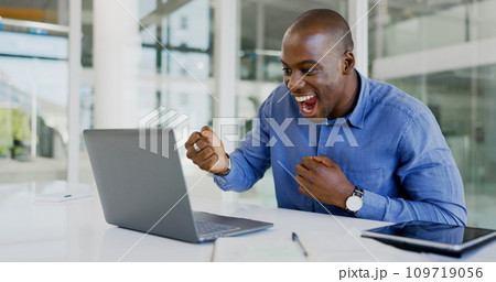 Business man, winner and computer for success, winning and goals of stock market increase, sales or profit. Professional african trader with yes and wow for email news or trading on laptop in office Business man, winner and computer for success, winning and goals of stock market increase, sales or profit. Professional african trader with yes and wow for email news or trading on laptop in office 109719056