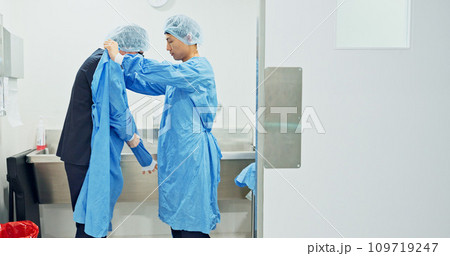 Team, doctors and washing hands, put on theatre gown or prepare to start surgery or operation in hospital. Surgeon cleaning with water, medical healthcare or nurse help man wipe for hygiene or safety Team, doctors and washing hands, put on theatre gown or prepare to start surgery or operation in hospital. Surgeon cleaning with water, medical healthcare or nurse help man wipe for hygiene or safety 109719247