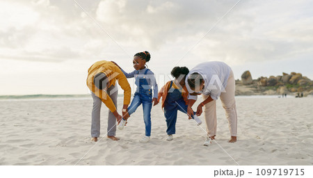 Summer, sand and a black family at the beach with shoes for walking or running together. Happy, travel and African children with parents getting ready for playing by the sea during a holiday 109719715
