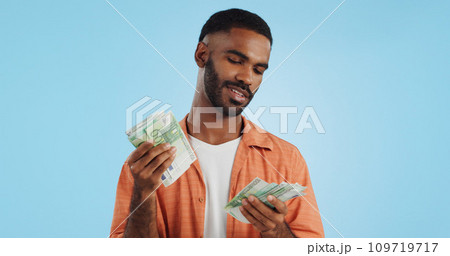 Man, count cash and happy in studio with success, bonus or promotion with winning by blue background. Investor, trader or person with Euro money, salary or savings with smile for financial freedom go Man, count cash and happy in studio with success, bonus or promotion with winning by blue background. Investor, trader or person with Euro money, salary or savings with smile for financial freedom go 109719717