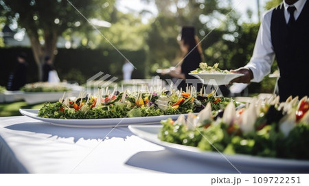 Waiter carrying a plate of food on some festive event, party or wedding reception 109722251