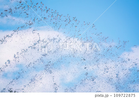 Splashes of water against the blue sky background 109722875
