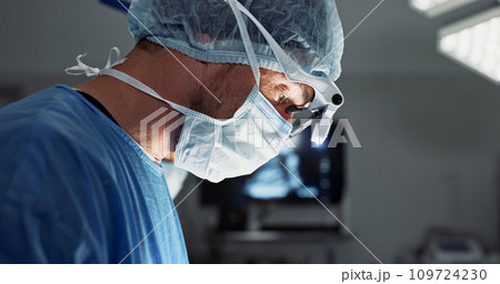 Surgery, hospital and doctor with face mask for operation, medical emergency and service in theater. Healthcare, procedure and closeup of surgeon with light for patient injury, wellness and accident Surgery, hospital and doctor with face mask for operation, medical emergency and service in theater. Healthcare, procedure and closeup of surgeon with light for patient injury, wellness and accident 109724230