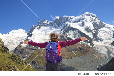 Teenager girl enjoying the panorama of Gorner Glacier and Monte Rosa summit in Switzerland, Zermatt area 109724477