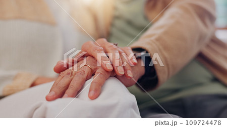 Hands, support and a senior couple closeup in their home for love, sympathy or trust during retirement. Hope, healing and empathy with elderly people on a sofa in the living room of their home 109724478