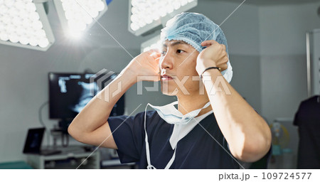 Surgery, doctor and man with face mask in hospital theatre for medical service, preparation and operation. Healthcare, safety scrubs and person with uniform for emergency, procedure and protection Surgery, doctor and man with face mask in hospital theatre for medical service, preparation and operation. Healthcare, safety scrubs and person with uniform for emergency, procedure and protection 109724577