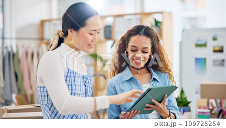 Woman, fashion designer and tablet in meeting, planning or logistics in small business together at office. Creative female person or employees working on technology for clothing design or startup 109725254