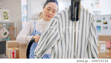 Asian woman, fashion designer and steam clothing in logistics, small business or quality service at boutique. Female person in dry cleaning, retail store or product preparation for delivery at shop 109725316