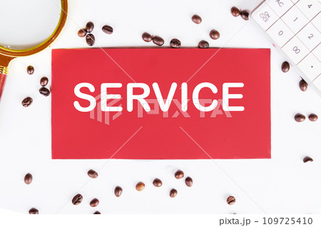 SERVICE writing on a red card on a white background with coffee beans and a magnifying glass SERVICE writing on a red card on a white background with coffee beans and a magnifying glass 109725410