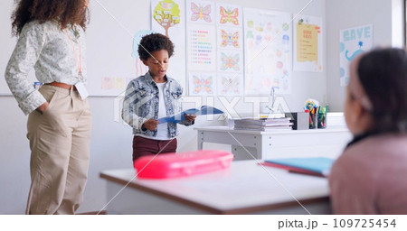 Child, kid reading and classroom with talking speaker, book and education at a school. Students, learning and notebook with development, knowledge and study with story discussion of youth assessment 109725454